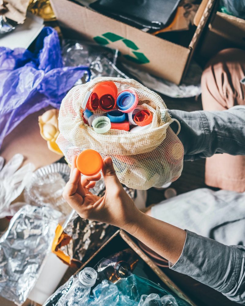 woman-sorting-different-waste-girl-holding-a-plastic-cap-recycling-and-ecology-concept-.jpg